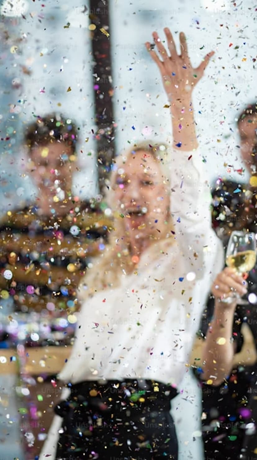 Person celebrating with confetti in the air